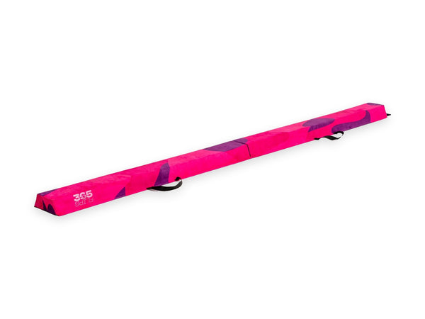 365 Flips foam balance beam laid out flat, pink with a purple pattern and carry handles